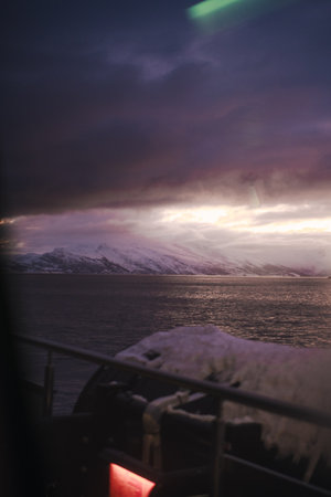 Winter sunset view over fjord between arctic mountains in the Lyngen Alps Norwayの写真素材