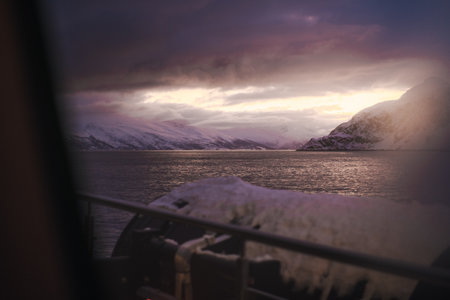 Sunset winter view over fjord between arctic mountains in the Lyngen Alps Norwayの写真素材