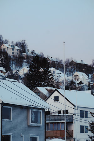 Colourful houses on hillside covered in snow in the center of Tromso, Norwayの写真素材
