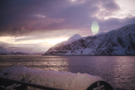 Sunset view over fjord between arctic mountains in the snowy Lyngen Alps Norwayの写真素材