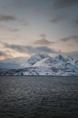 Snow covered mountains of the Lyngen Alps at sunset in winter in northern Norwayの写真素材