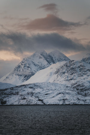 Snow covered mountains of the Lyngen Alps at sunset in northern Norway in winterの写真素材