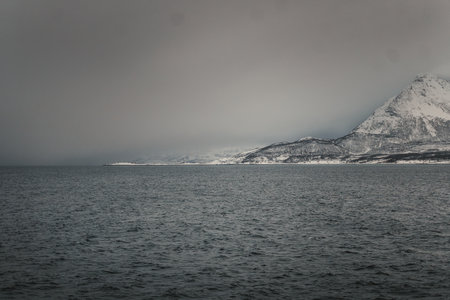 Foggy arctic ocean coastline in the Lyngen Alps of northern Norway winter sunsetの写真素材
