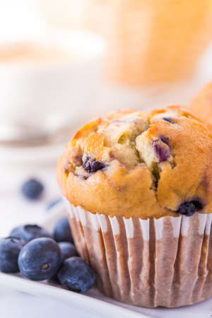 Blueberry muffins with a breakfast settingの写真素材