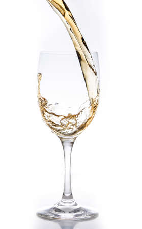 White wine being poured into a glass の写真素材
