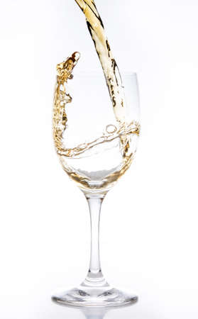 White wine being poured into a glass の写真素材