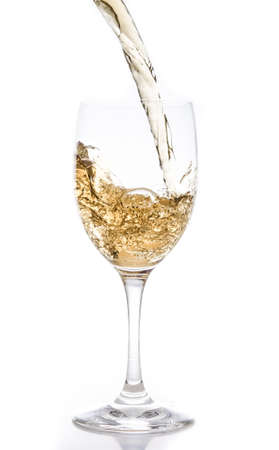 White wine being poured into a glass の写真素材