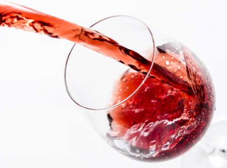 Red wine being poured into a glass の写真素材
