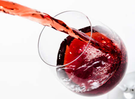 Red wine being poured into a glass の写真素材
