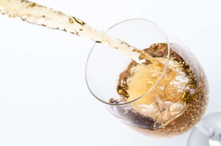 White wine being poured into a glass の写真素材