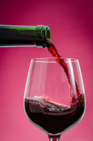 Red wine being poured into a glass の写真素材