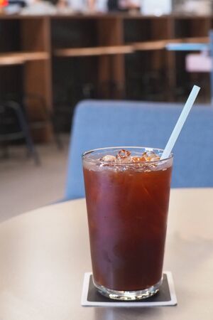 A glass of ice Americano on wooden table in cafe.の写真素材