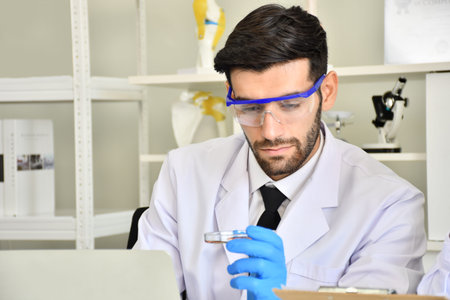 Scientists show test tubes that are satisfactory. Scientists have successfully discovered a cure for...