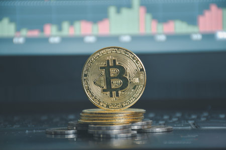 Bitcoin coins are placed on a candlestick background.