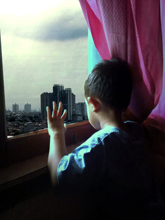 a child looks at the future from the window