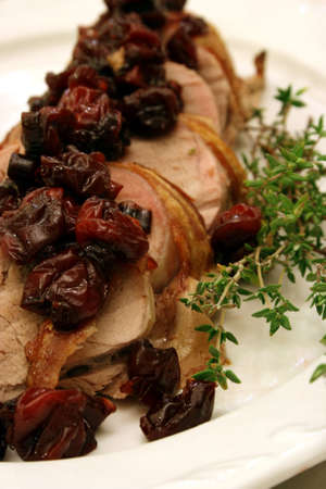Bacon wrapped pork tenderloin topped with cherriesの写真素材