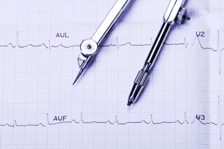EKG printout and compasses under  monochromatic source