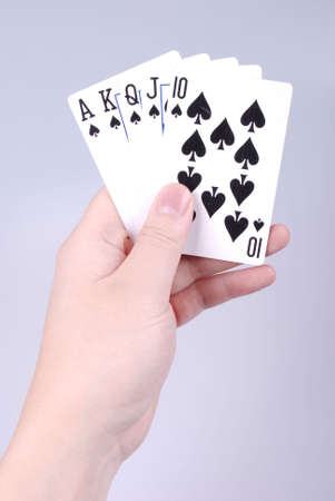 Poker in a hand with gray backgroundの写真素材