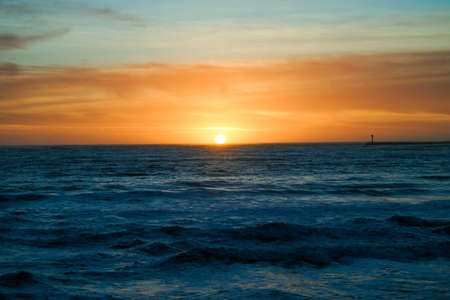 Sunset in Half Moon Bay California creating beautiful colors over ocean.の写真素材