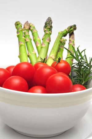 Cherry Tomatos and Asparagus in a light colored bowl with thymeの写真素材