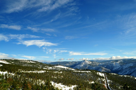 Looking over the forest and mountain tops of the California Sierra Nevada mountains, image contains...