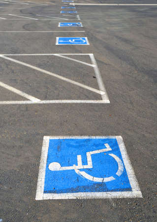 Multiple empty handicap parking spaces in an asphalt parking lotの写真素材