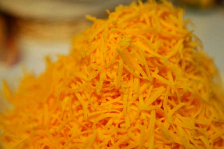 Closeup of grated orange cheese の写真素材