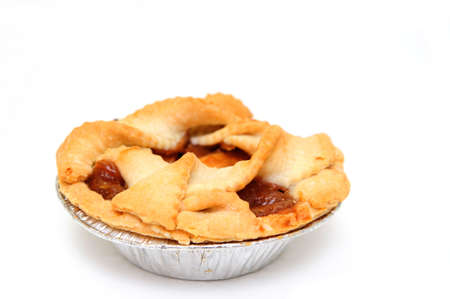 Apple pie for one on a white background in an aluminium pie panの写真素材