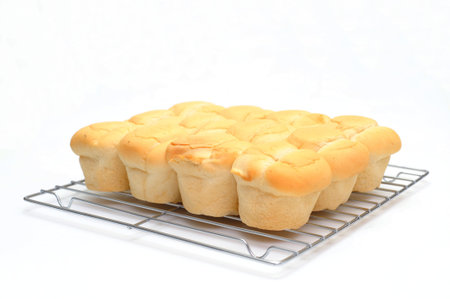 Brown and serve dinner rolls on a wire bakers cooling rack