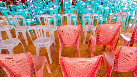 Red And Turquoise Plastic Chairs, Arranged Neatly On The Groundの写真素材