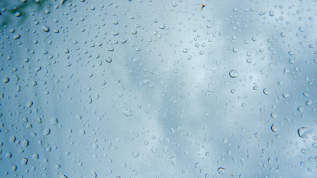 Droplets Of Raindrops That Stick To A Car Window During Drizzling Rainの写真素材