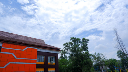An Office Building With An Orange And Brown Color Pattern, And A View Of A Cloudy Sky