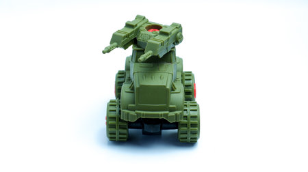 Green Military War Tank Shaped Children's Toy Car On Isolated White Background, Photographed With Rule Of Thirds Compositionの写真素材