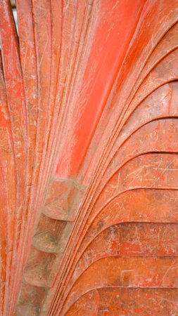 Close Up View Of The Side View Of The Legs Of The Orange Plastic Chair, Arranged Neatly And Tightly, Photo Taken In Portrait Modeの写真素材