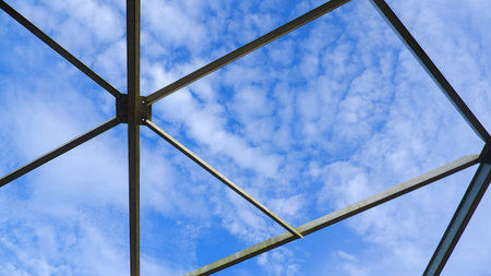 Steel Truss Bridge Connecting Construction With Blue And Bright Sky Background