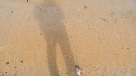 A Shadow Of A Man In The Sand Of Tanjung Kalian Beach, Indonesiaの写真素材