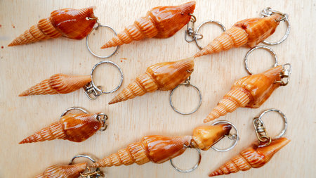 Key Chains Made From Snail Shells With A Cream Background