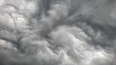 The view of swirling storm clouds filling the sky is intense and dramatic.の写真素材