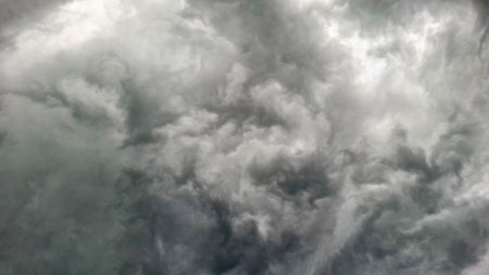 Dramatic display of dark storm clouds swirling and layering forming a formidable weather scene....
