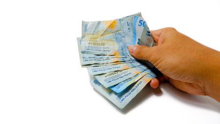 Hand Holding Indonesian Rupiah Banknotes, IDR 50000 Cash Money Concept