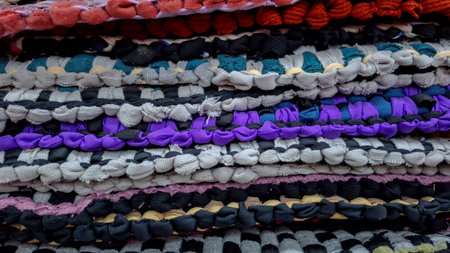 Textured Background of Stacked Black, White, and Red Rag Rugsの写真素材