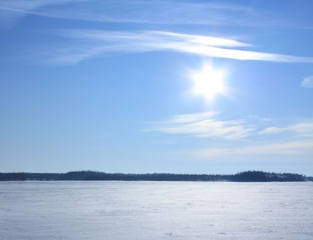 Winter landscape with blue sky and sunの写真素材