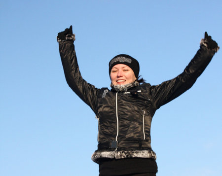 Happy woman on a background of blue sky