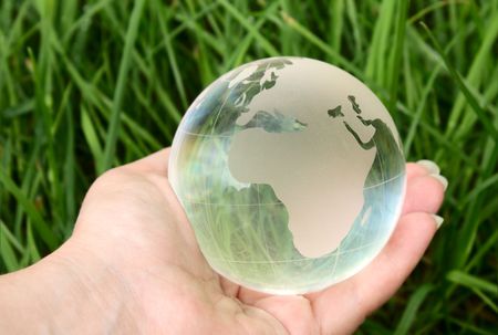 glass ball in the hand of the planetの写真素材