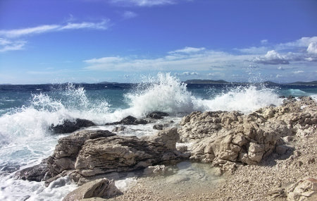 Impact of large waves against rocks in the beach