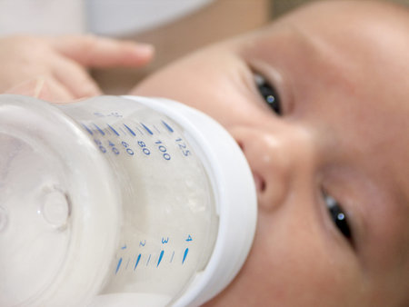 Baby Feeding from infantile feeding-bottle with milk