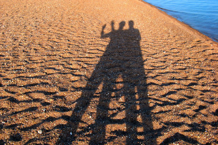 courting couple shadow on the beach in Egypt - Nuweibaの写真素材