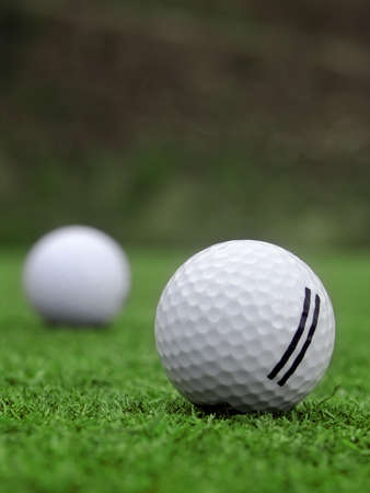 Golf - detail ball with hole on greenの写真素材