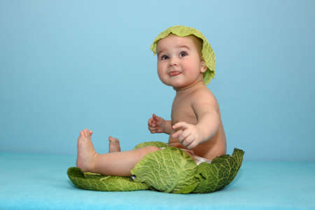 baby sitting in freshly leaf sproutの写真素材