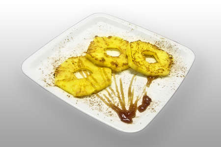 grilled pineapple with maple toppingの写真素材